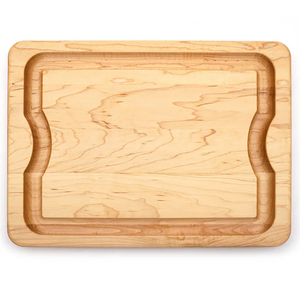 The J.K. Adams Maple BBQ Cutting Board features a rectangular shape, recessed groove, and indented sides for grip, shown against a white background.