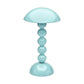 The Addison Ross Bobbin Cordless Lamp Collection features a light blue, bobbin-shaped LED lamp with a dome shade and four stacked spheres, offering adjustable lighting in a portable, stylish design.