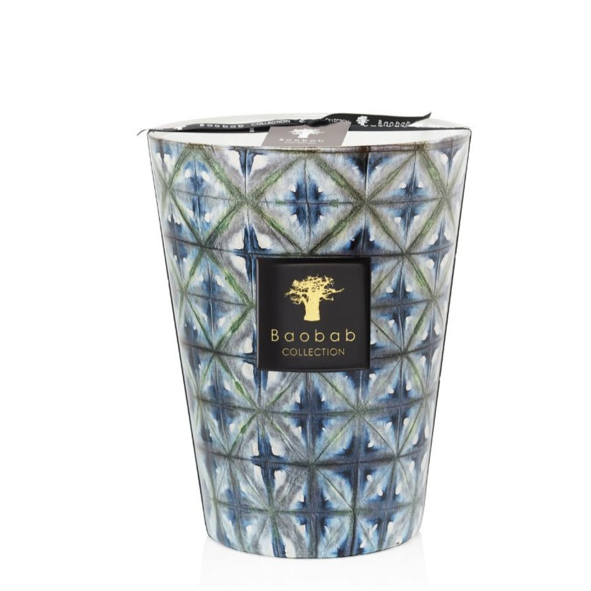 Blue and white patterned Baobab Collection Bohomania Kilan scented candle in a geometric print glass container with a black and gold label.