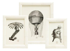 The Velden Frame Collection by Pigeon & Poodle showcases three black and white illustrations—a cactus, a hot air balloon, and a vintage diving helmet—each framed and detailed against a crisp white background.