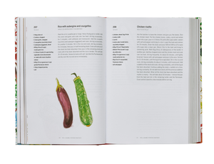 An open best-selling Phaidon cookbook displaying recipes and illustrations of an eggplant and a zucchini.