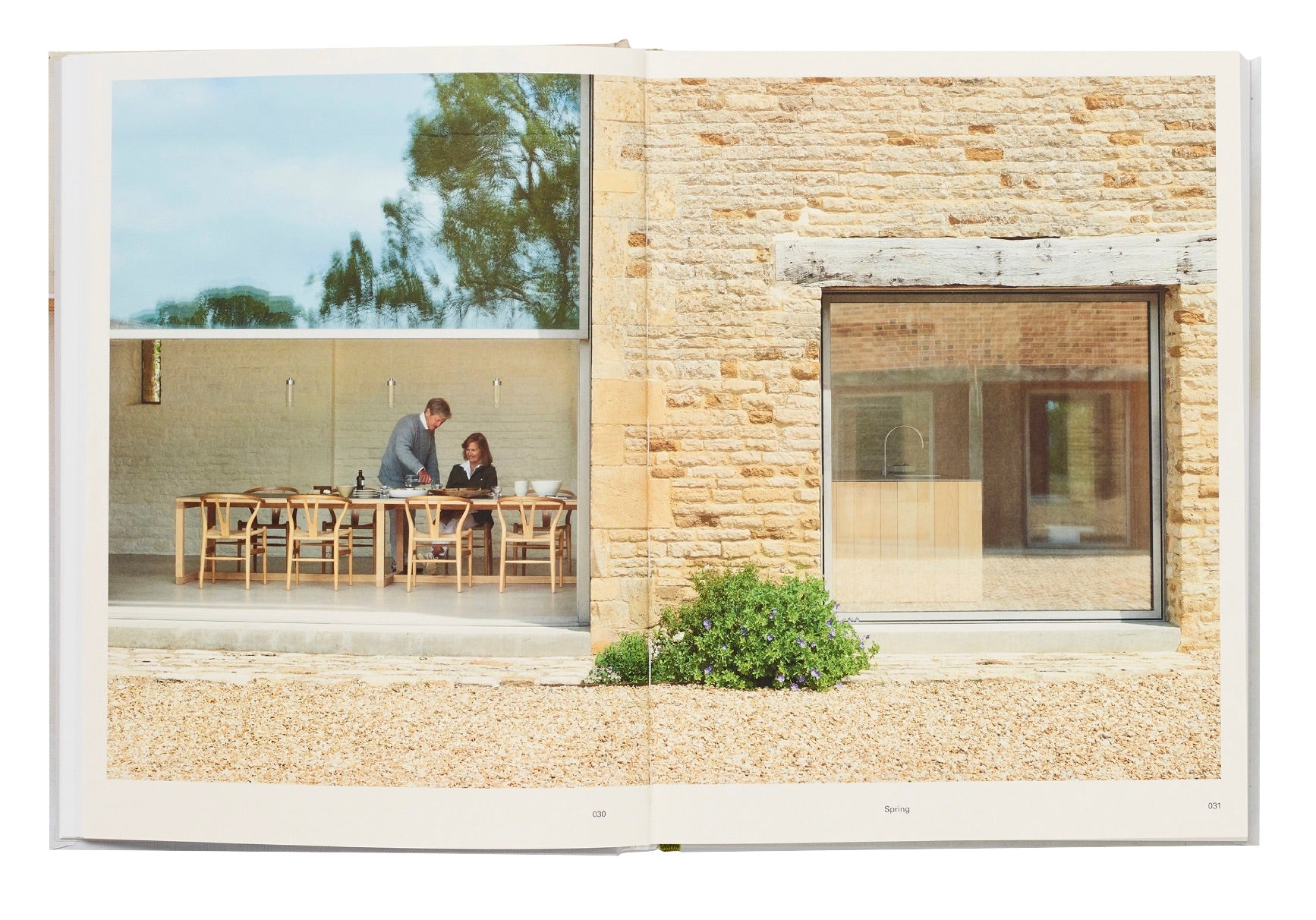 Two individuals engaged in conversation about their recipe collection while seated at an outdoor table, as seen in a photograph within an open Phaidon Home Farm Cooking book.