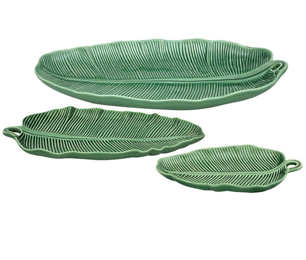 Part of the Bordallo Pinheiro Banana Leaves Platter Collection, this set includes three green ceramic plates shaped like banana leaves in different sizes.