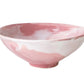 The Geode Bowl Collection by Paul Schneider Ceramics features an elegant pink and white marbled swirl design, adding unique style to any setting.