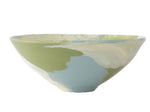 The Geode Bowl Collection by Paul Schneider Ceramics features a ceramic bowl with a glossy finish and a soft green, blue, and cream marbled swirl pattern for a colorful touch.