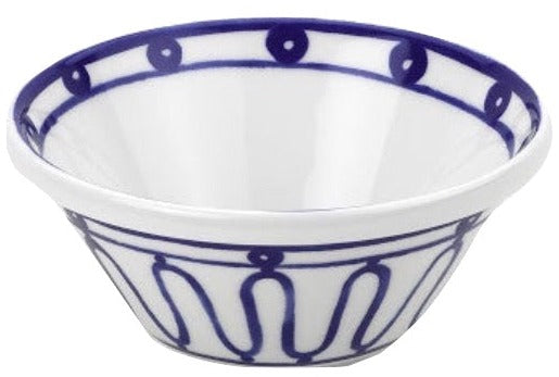 A white ceramic bowl from Themis Z’s Kyma Blue Dinnerware Collection features blue geometric patterns, inspired by the Greek Aegean Sea.