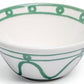 White ceramic bowl from the Serenity Green Dinnerware Collection by Themis Z, featuring a green line and circular rim pattern with a subtly flared, organic shape inspired by Themis Z tableware.
