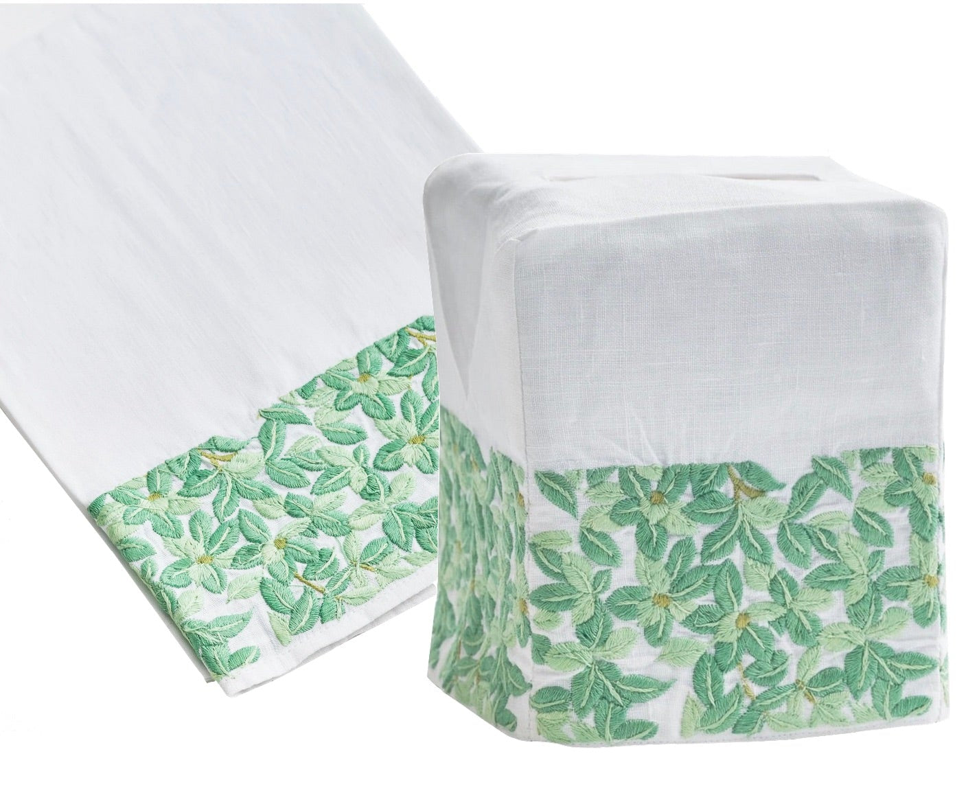 Introducing the Boxwood Bath Collection by Haute Home—a tissue box cover and matching tip towel crafted from Italian linen, adorned with a green leafy pattern on a crisp white background.
