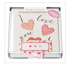 The Karen Adams I Love You Sticker Gift Enclosure Set includes a clear box with a "I love you" notepad, three glittered hearts, and a "stickers!" label—great for pairing with hand-glittered cards.