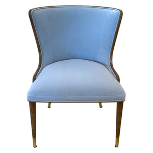 Front view of the Marino Dining Chair by McCann Design Group featuring blue upholstery, solid walnut legs, and sleek bronze sabots on the feet.