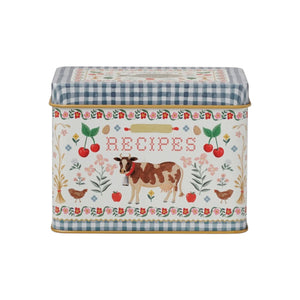 The Rifle Paper Co. Home Sweet Home Collection tin recipe box features a blue gingham lid, floral border, and farm animal accents—a charming farmhouse decor piece with "RECIPES" on the front to add vintage style to your kitchen.