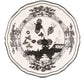 A decorative ceramic plate from the Ginori 1735 Oriente Italiano Albus Dinnerware Collection, featuring a black and white floral design with a central flower and ornamental border, inspired by classic Florentine elegance.