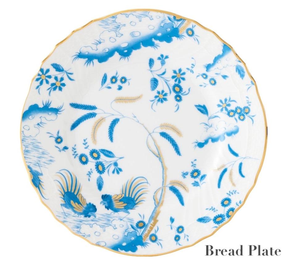 Ginori 1735’s Oro Di Doccia Turchese bread plate features blue and gold floral and bird designs on white porcelain, with hand-painted scalloped gold edges and signature Ji Ondori roosters for a charming accent.