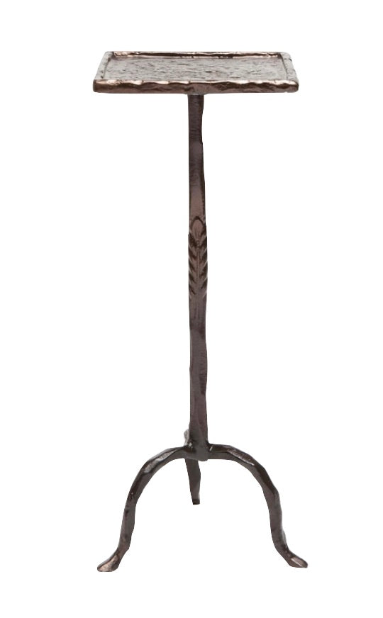 The Maddy Bronze Twisted Iron Side Table by Made Goods is a tall, narrow stand with a square top and chunky textured tripod base featuring subtle laurel leaf details.