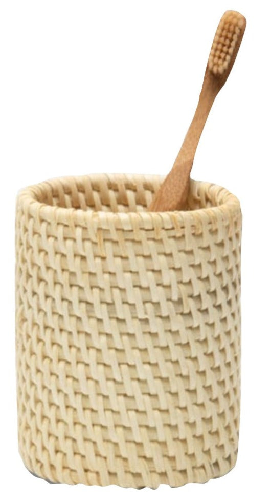 The Dalton Bath Collection by Pigeon & Poodle features a wooden toothbrush elegantly stored in a beige holder, highlighting detailed craftsmanship and carefully handmade rattan weaving.