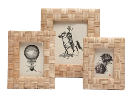 The Grasse Frame Collection by Pigeon & Poodle includes three extra-thick rattan frames, each featuring a black and white illustration: a hot air balloon, a horse rider, and a plant.