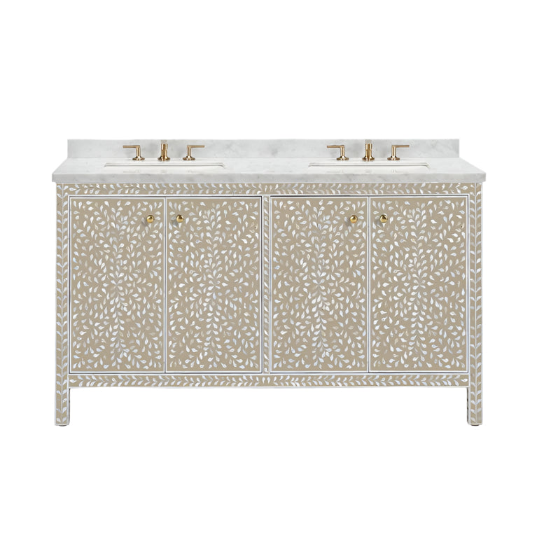 The Azalea Vanity Collection by Made Goods is a free-standing double-sink vanity with gold faucets, a white marble top, and beige cabinets adorned with a white floral inlay and mother-of-pearl accents.