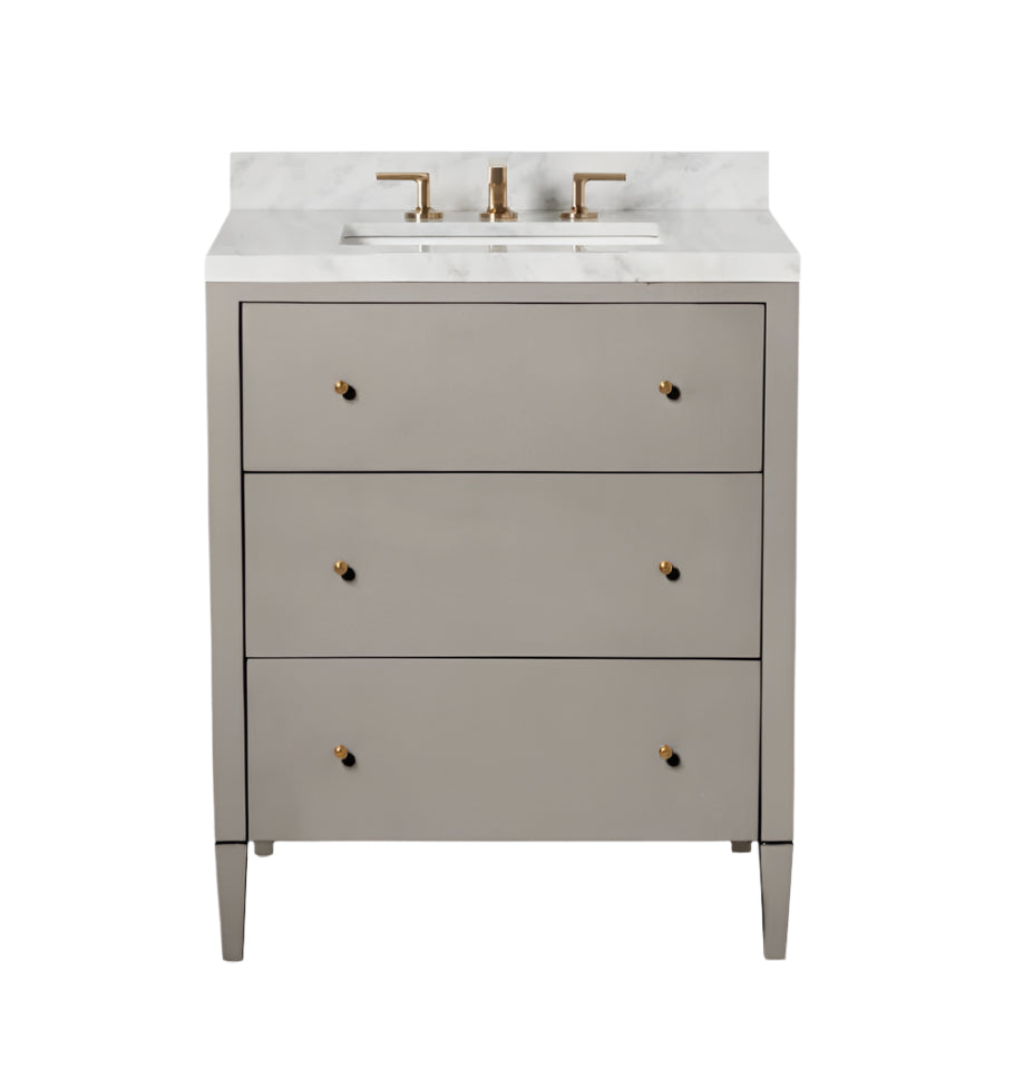 The Conrad Vanity Collection by Made Goods features a modern floating design with three soft-close gray drawers, a white marble countertop, and gold faucet fixtures.
