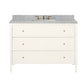 The Conrad Vanity Collection by Made Goods features a white floating bathroom vanity with soft-close drawers, marble countertop, rectangular sink, and brass faucet fixtures.