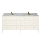 The Conrad Vanity Collection by Made Goods features a white double sink base, soft-close drawers with brass knobs, a marble countertop, and two gold-colored faucets.