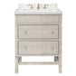 The Isla Vanity Collection by Made Goods features a light gray freestanding cabinet with three drawers, gold knobs, white countertop, integrated sink, and gold faucet—an elegant choice for stylish bathrooms.