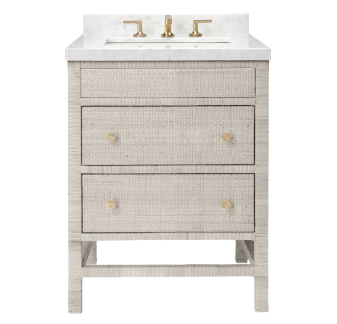 The Isla Vanity Collection by Made Goods features a light gray freestanding cabinet with three drawers, gold knobs, white countertop, integrated sink, and gold faucet—an elegant choice for stylish bathrooms.