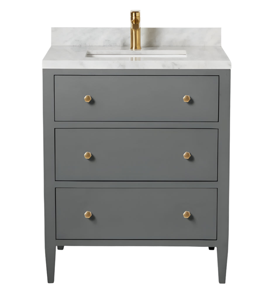 The Jarin Vanity Collection by Made Goods features a gray freestanding vanity with three drawers, gold knobs, a white marble countertop, and a gold faucet, offering elegant style and practical storage for your bathroom.