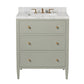 The Jarin Vanity Collection by Made Goods features a light gray freestanding vanity with three drawers, brass hardware, a white marble countertop, and a brass faucet.