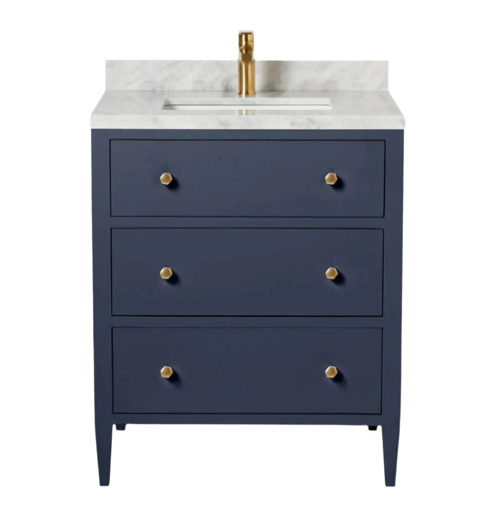 The Jarin Vanity Collection by Made Goods features a navy blue floating vanity with three drawers, gold knobs, a white marble countertop, and a gold faucet for modern bathroom elegance.