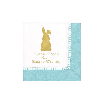 Caspari Bunny Kisses and Easter Wishes Cocktail Napkins are white, biodegradable, with a blue border and gold bunny silhouette. Eco-friendly and perfect for festive celebrations while caring for the planet.