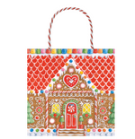 Festive and fun, Caspari's Gingerbread House Collection gift bag features a candy-adorned house design with red and white striped handles—perfect for holiday gifting.
