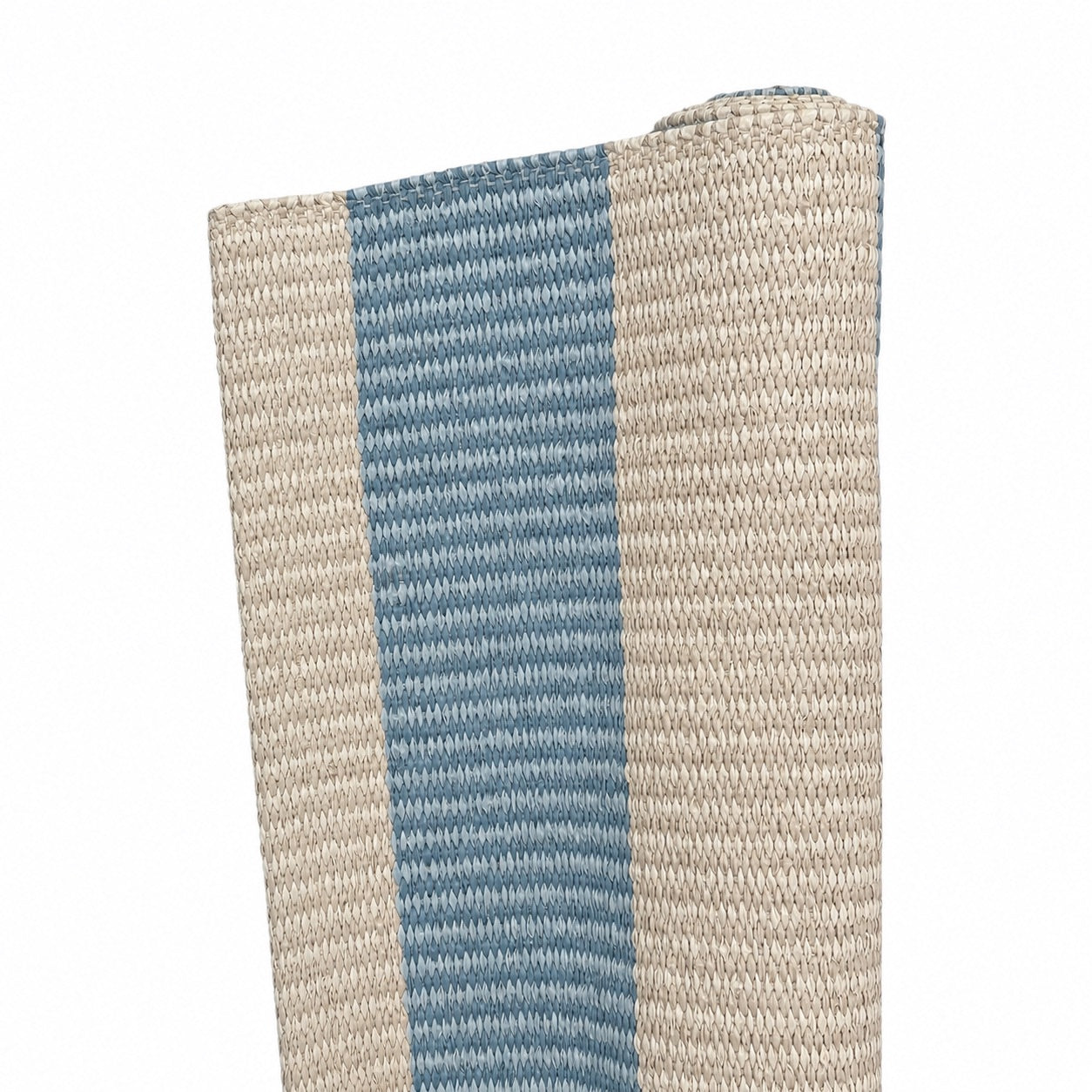 A close-up of the Magdalena York Amy Stripe in Medium Blue rug, showcasing its artisanal beige and blue vertical stripes, partially rolled up against a white background.