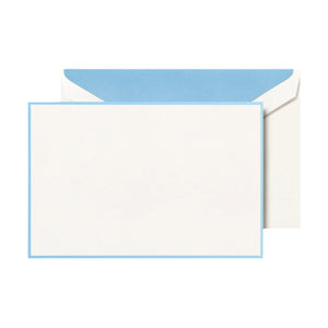 The Crane Newport Blue Bordered Correspondence Note Card Set features a blank white cotton paper card with a Newport blue border on a matching envelope with a blue interior flap, set on a neutral background.