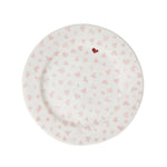 The Juliska Love You More Decor and Tabletop Collection features a white ceramic dessert plate with light pink hearts and a single red heart near the rim, adding charm to your sweetheart tableware. Photographed on a white background.
