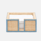 The Gable Natural/White Barware Collection by Blue Pheasant features a woven rectangular napkin holder with leather trim and white napkins against a plain background.