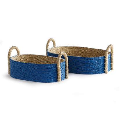 The Tiana Blue Seagrass Short Oval Basket Collection by Napa Home & Garden features two handwoven baskets with blue sides and natural rope handles—ideal designer accents for any space.