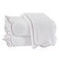 These two folded white terry towels from the Matouk Cairo Scallop Bath Collection feature scalloped edges with pink borders, crafted from luxurious long-staple cotton for ultimate softness.