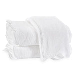 Two neatly folded white terry towels from the Matouk Cairo Scallop Bath Collection, crafted with premium long-staple cotton, stacked atop one another against a plain white background.