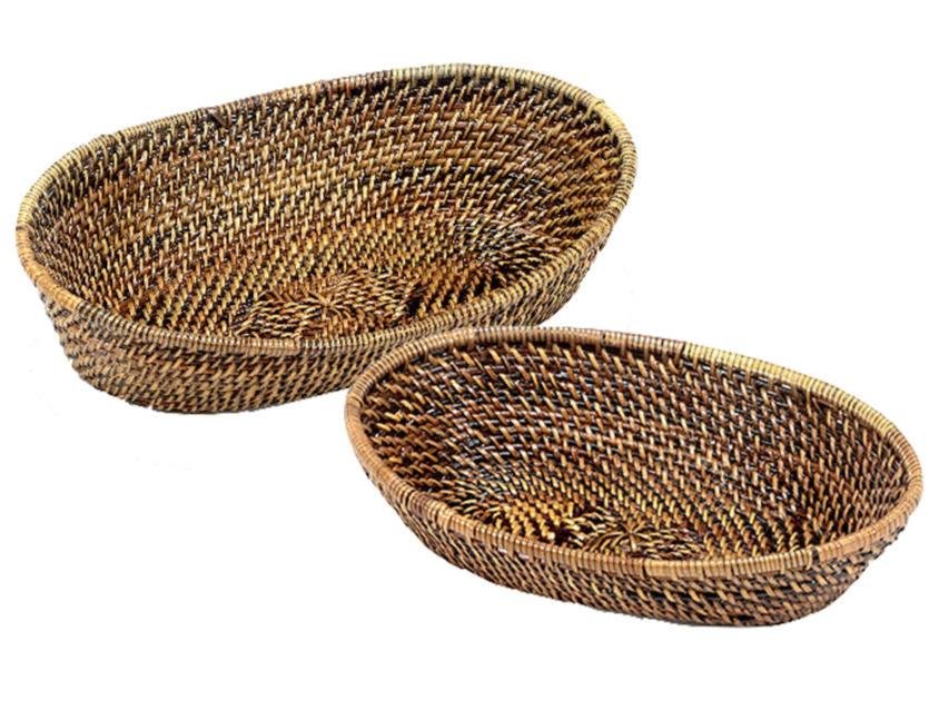 The Calaisio Oval Bread Basket Collection features two empty, eco-crafted oval baskets—one large, one small—expertly handwoven and placed side by side on a white background, perfect for serving freshly baked bread.