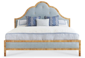 The Sloane King Bed by Mr & Mrs Howard features a light wood frame, blue upholstered headboard, and three blue and white decorative pillows on crisp white bedding.