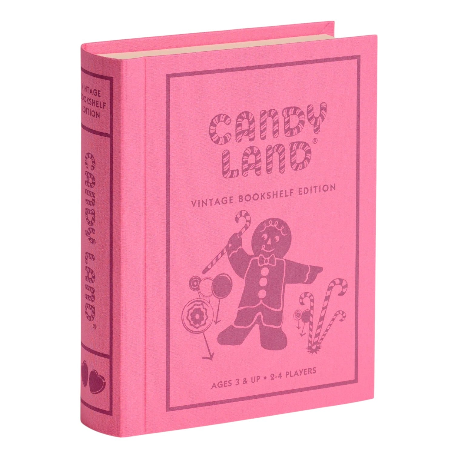 A pink, fabric-wrapped book-shaped box from WS Game Company’s Vintage Bookshelf Board Games, featuring Candy Land-themed artwork with a gingerbread figure and candy canes on the cover.