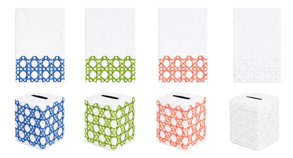 Four hand towels and four matching tissue box covers from Haute Home’s Cane Bath Collection, crafted from white Italian linen and featuring geometric patterns in blue, green, coral, and white, arranged in a row on a white background.