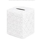 The Haute Home Cane Bath Collection features a white ceramic cube-shaped piggy bank with a geometric textured pattern, reminiscent of an elegant tissue box cover, and a coin slot on top.