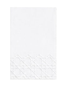 Haute Home’s Cane Bath Collection features a white rectangular Italian linen napkin with a geometric lattice pattern along the bottom edge. The napkin has a plain background and appears unused.