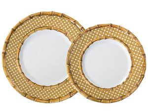 Two round plates from the Juliska Bamboo Caning Melamine Dinnerware Collection, featuring white centers and gold bamboo lattice rims, overlap each other. Made from shatterproof melamine.