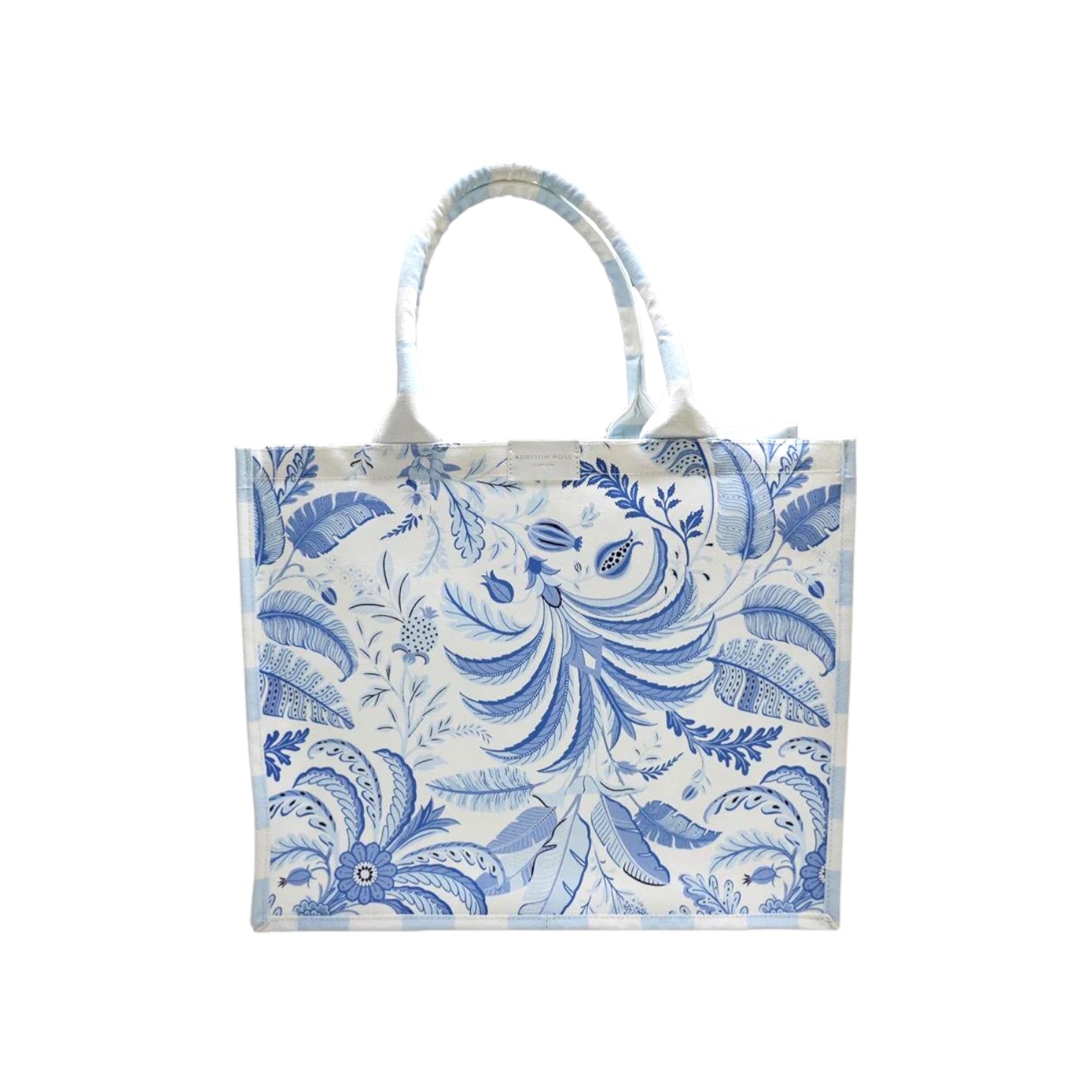The Addison Ross Palm Beach Tote Bag is a rectangular tote with two handles, showcasing a blue and white floral and leaf design on the front.