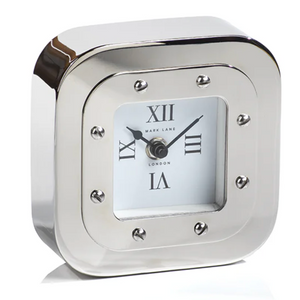 The Zodax Mark Lane Table Clock is a silver, square mantel clock with a nickel finish, Roman numerals, and black hour and minute hands set at 10:10.