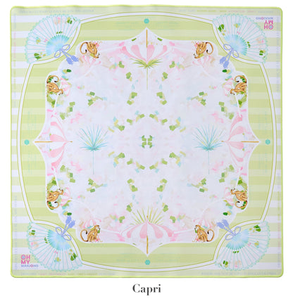 A square scarf from the Oh My Mahjong Mat Collection by Oh My Mahjong, featuring a symmetrical design with fans, umbrellas, and foliage in pastels on a pale background. Reminiscent of Mahjong mats, the border reads "Oh Mai Oh My!" and "Capri.