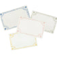 Four Berry & Thread Place Cards by Juliska, each a blank rectangle with decorative blue, green, yellow, and red borders, are arranged overlapping on a white background.
