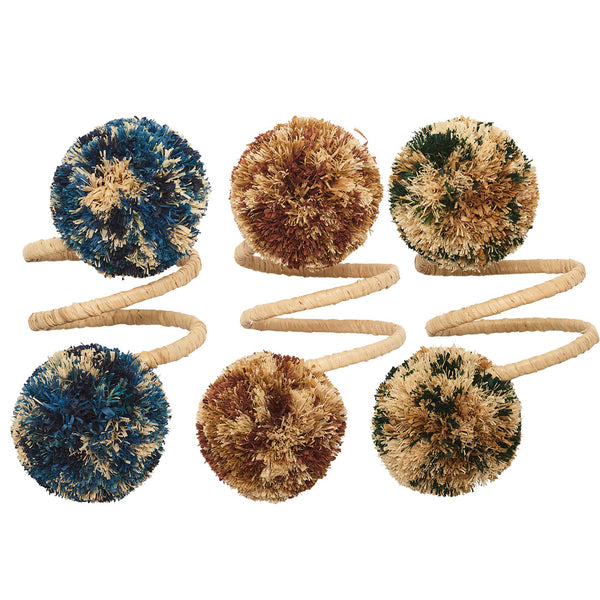 Kim Seybert's Casbah Napkin Rings embody an organic elegance with six multicolored fluffy pom-poms in blue, brown, and cream tones on spiraled bands.